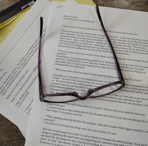 Glasses lying on manuscript and notebook. 